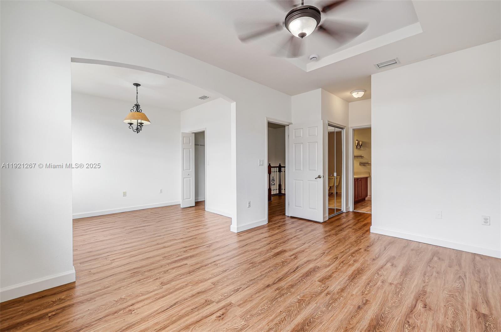 12230 Southwest 123rd Pass Miami, FL 33186 - Photo 44 of 64 a view of a livingroom with wooden floor and a ceiling fan