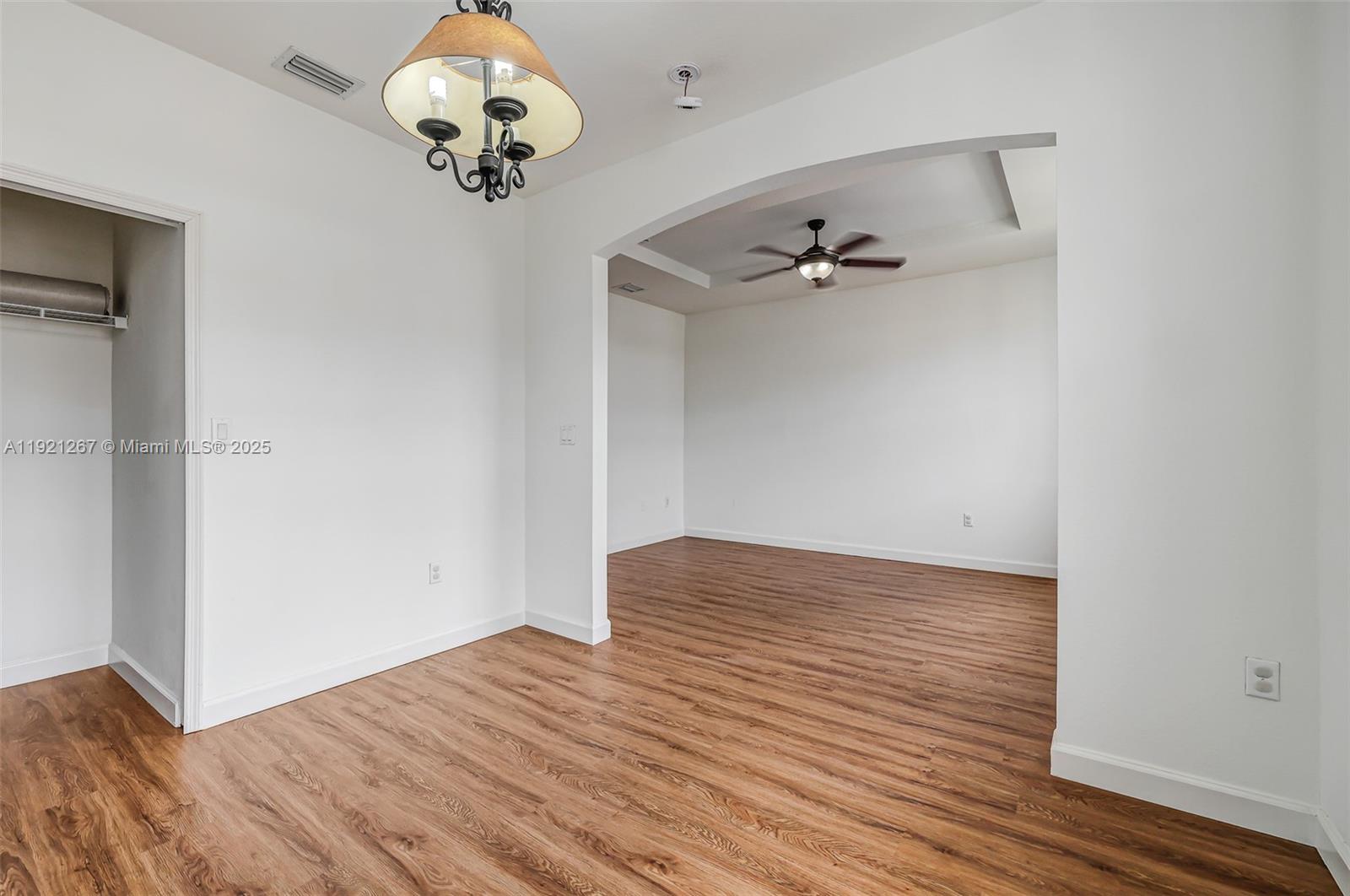 12230 Southwest 123rd Pass Miami, FL 33186 - Photo 46 of 64 an empty room with wooden floor fan and windows