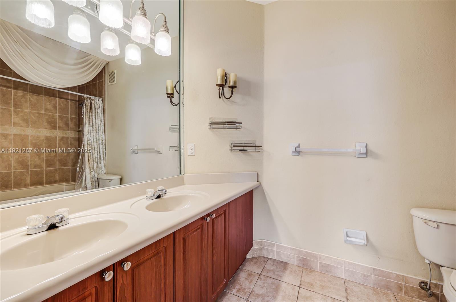 12230 Southwest 123rd Pass Miami, FL 33186 - Photo 48 of 64 a bathroom with a sink a toilet and shower