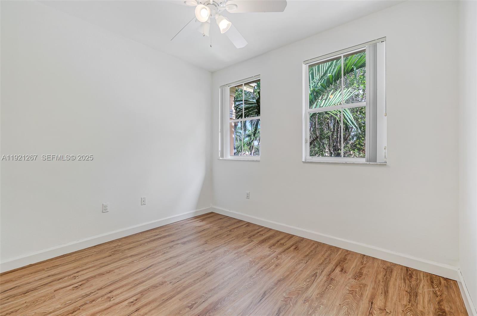 12230 Southwest 123rd Pass Miami, FL 33186 - Photo 50 of 65 an empty room with wooden floor and windows