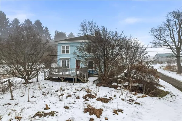 a view of a house with a snow in the yard