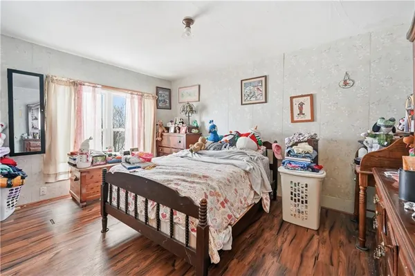 a bed room with a bed and a wooden floor