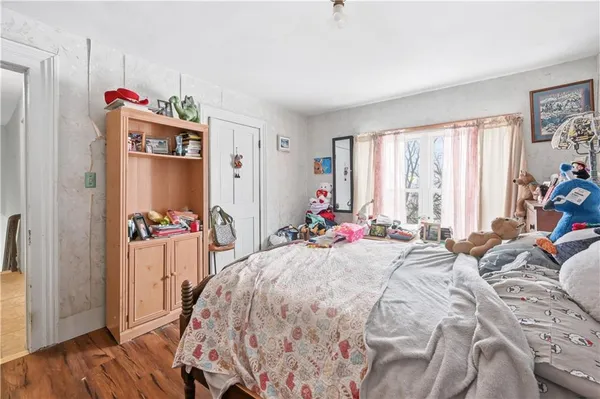 a bed room with a bed mirror and a window