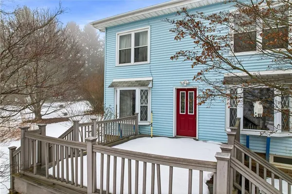 a house that has a tree in front of it
