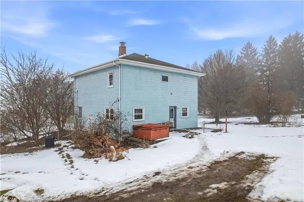 a backyard of a house with snow and yard