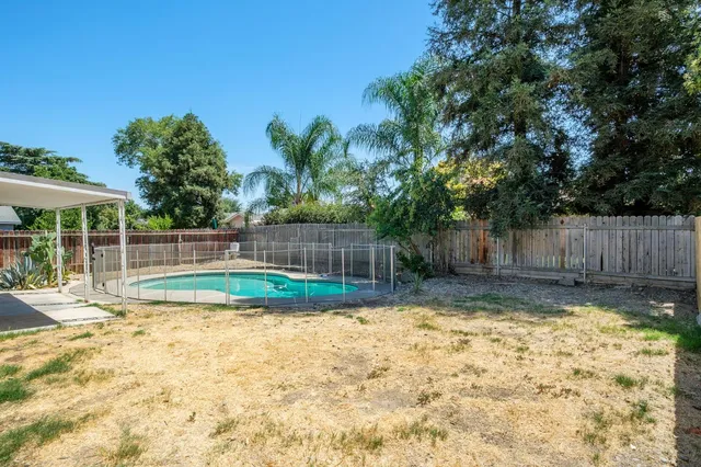 a view of swimming pool with wooden fence