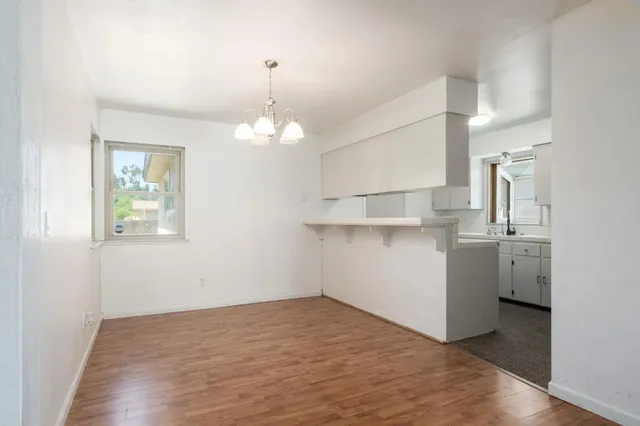 a view of kitchen and hallway with wooden floor