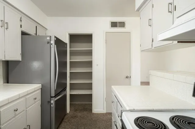 a kitchen with a refrigerator and a stove