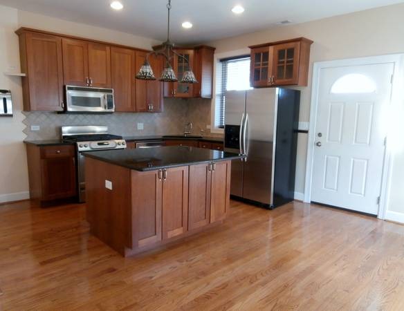 7611 North Sheridan Road Chicago, IL 60626 - Photo 5 of 11 a kitchen with stainless steel appliances granite countertop a stove a refrigerator and a microwave