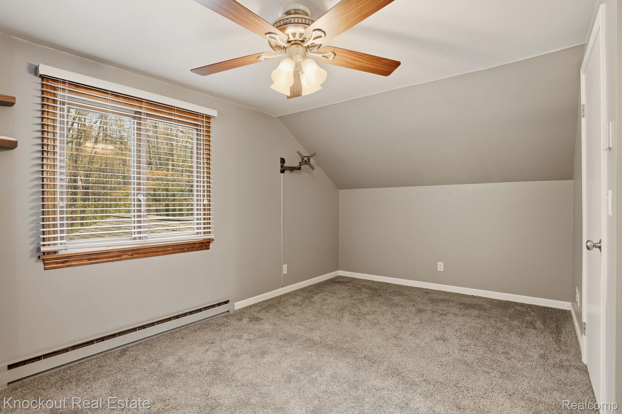 1608 South Pinnebog Road Bad Axe, MI 48413 - Photo 29 of 54 Bonus room with baseboard heating, a ceiling fan, light carpet, and lofted ceiling