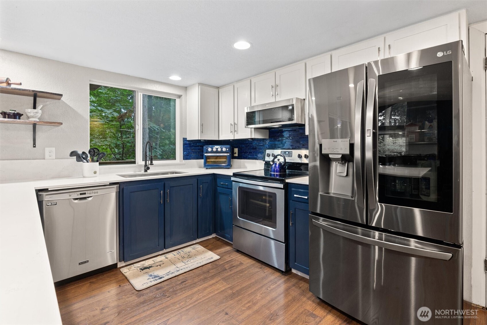 19833 95th Avenue Northeast Bothell, WA 98011 - Photo 14 of 39 a kitchen with a refrigerator stainless steel appliances a sink and a counter space
