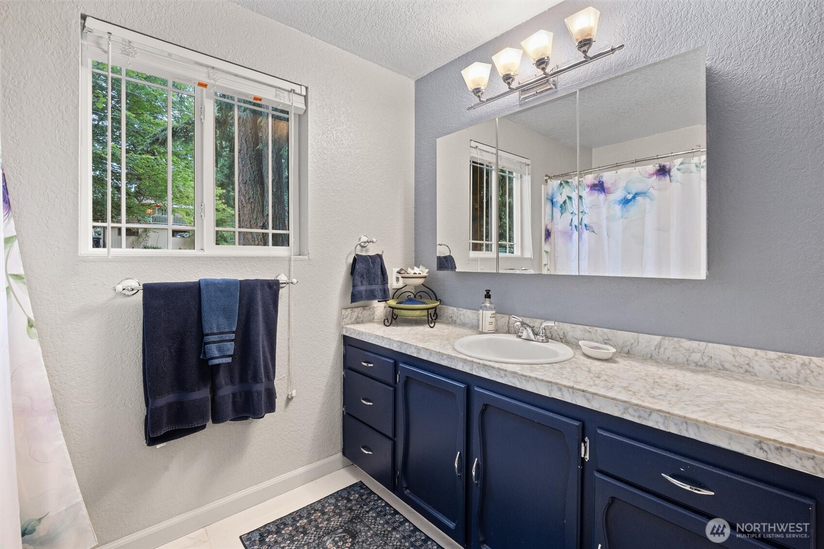 19833 95th Avenue Northeast Bothell, WA 98011 - Photo 22 of 39 a bathroom with a sink and a mirror