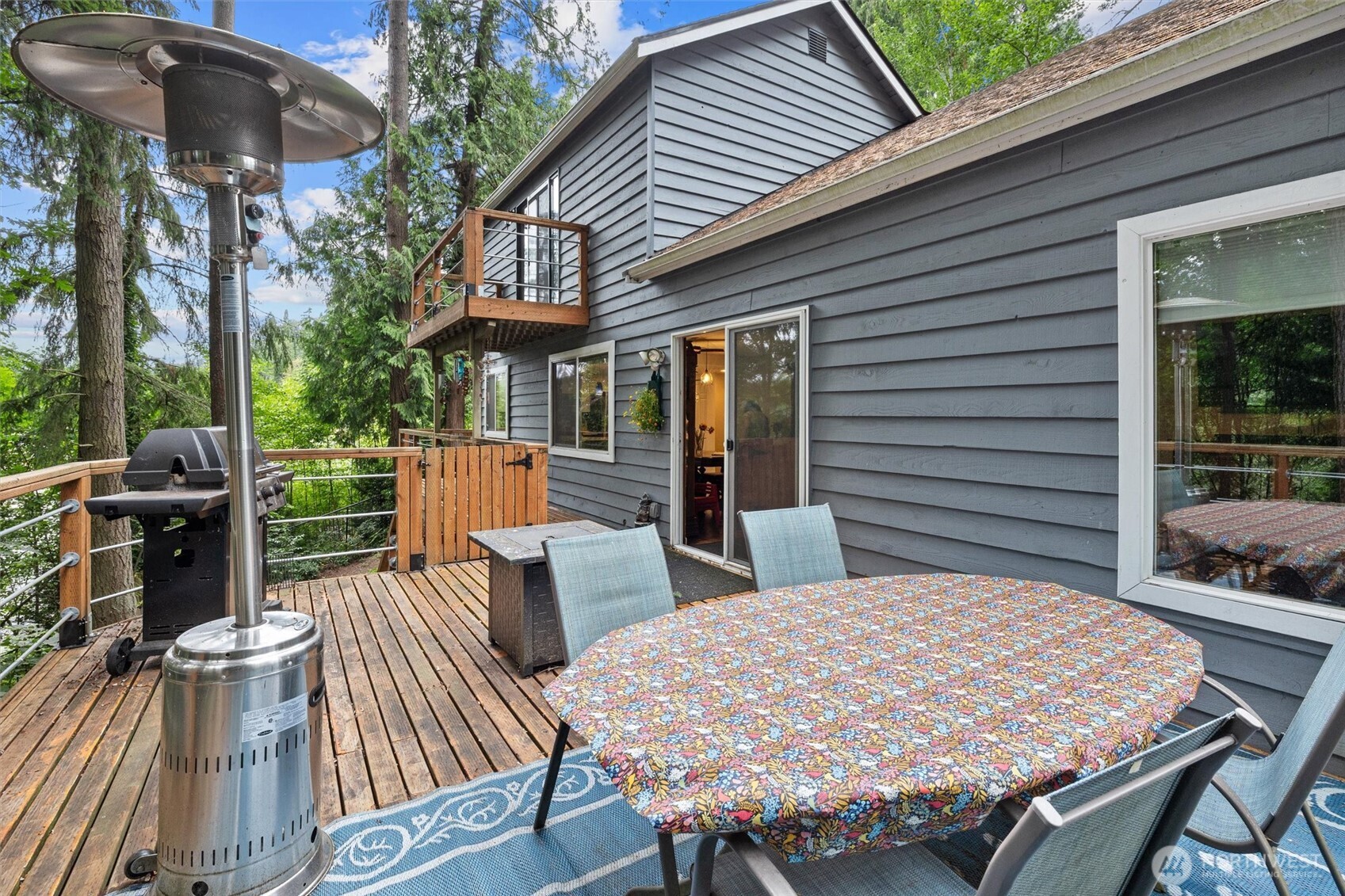 19833 95th Avenue Northeast Bothell, WA 98011 - Photo 33 of 39 a view of a patio with table and chairs a barbeque with wooden floor and fence
