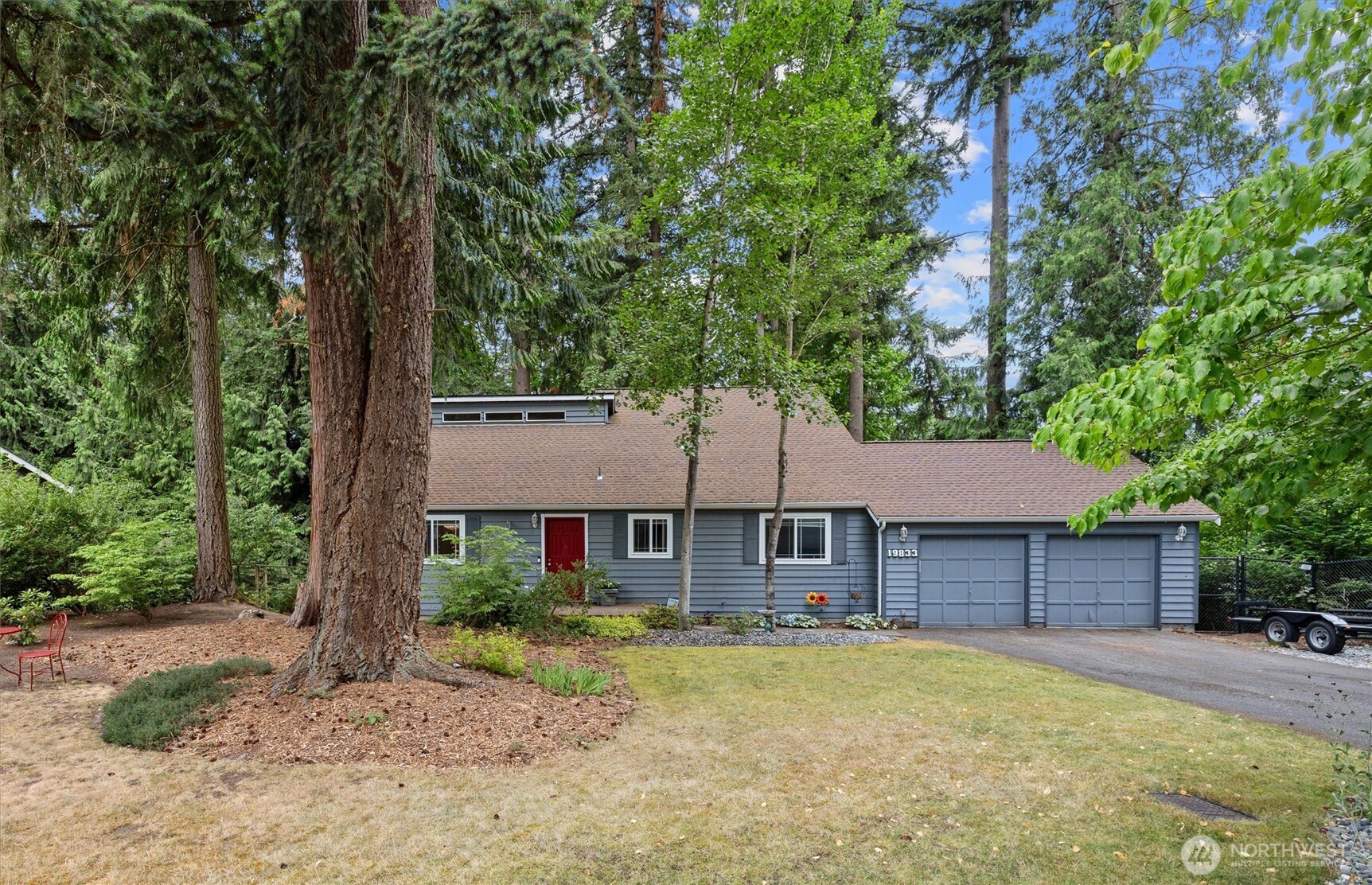 19833 95th Avenue Northeast Bothell, WA 98011 - Photo 4 of 39 a front view of a house with a yard