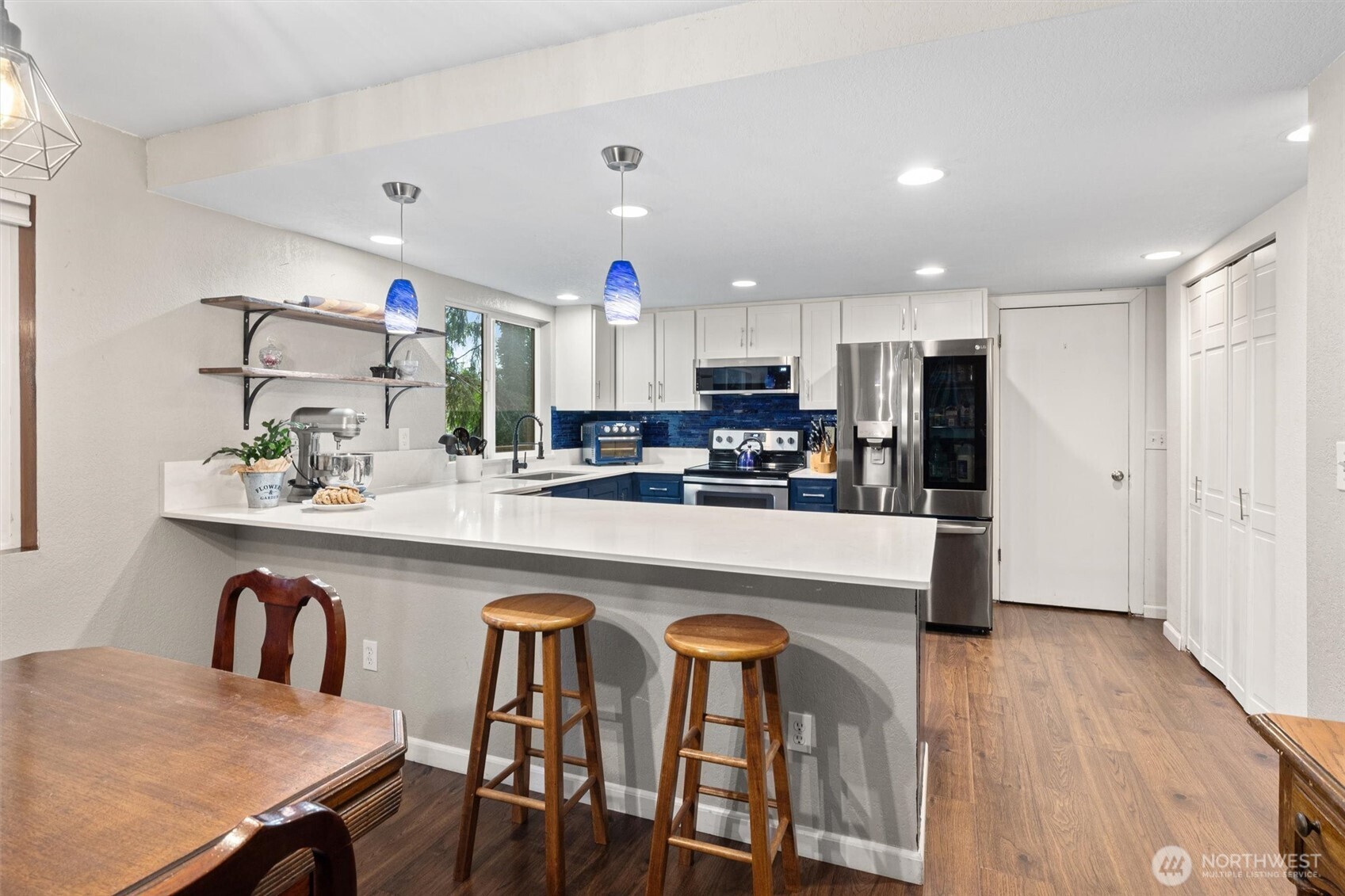 19833 95th Avenue Northeast Bothell, WA 98011 - Photo 5 of 39 a kitchen with stainless steel appliances a dining table chairs refrigerator and sink