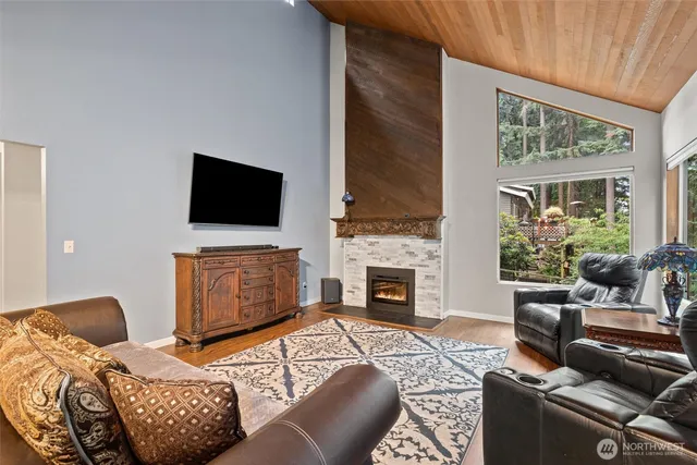 a living room with furniture a fireplace and a flat screen tv