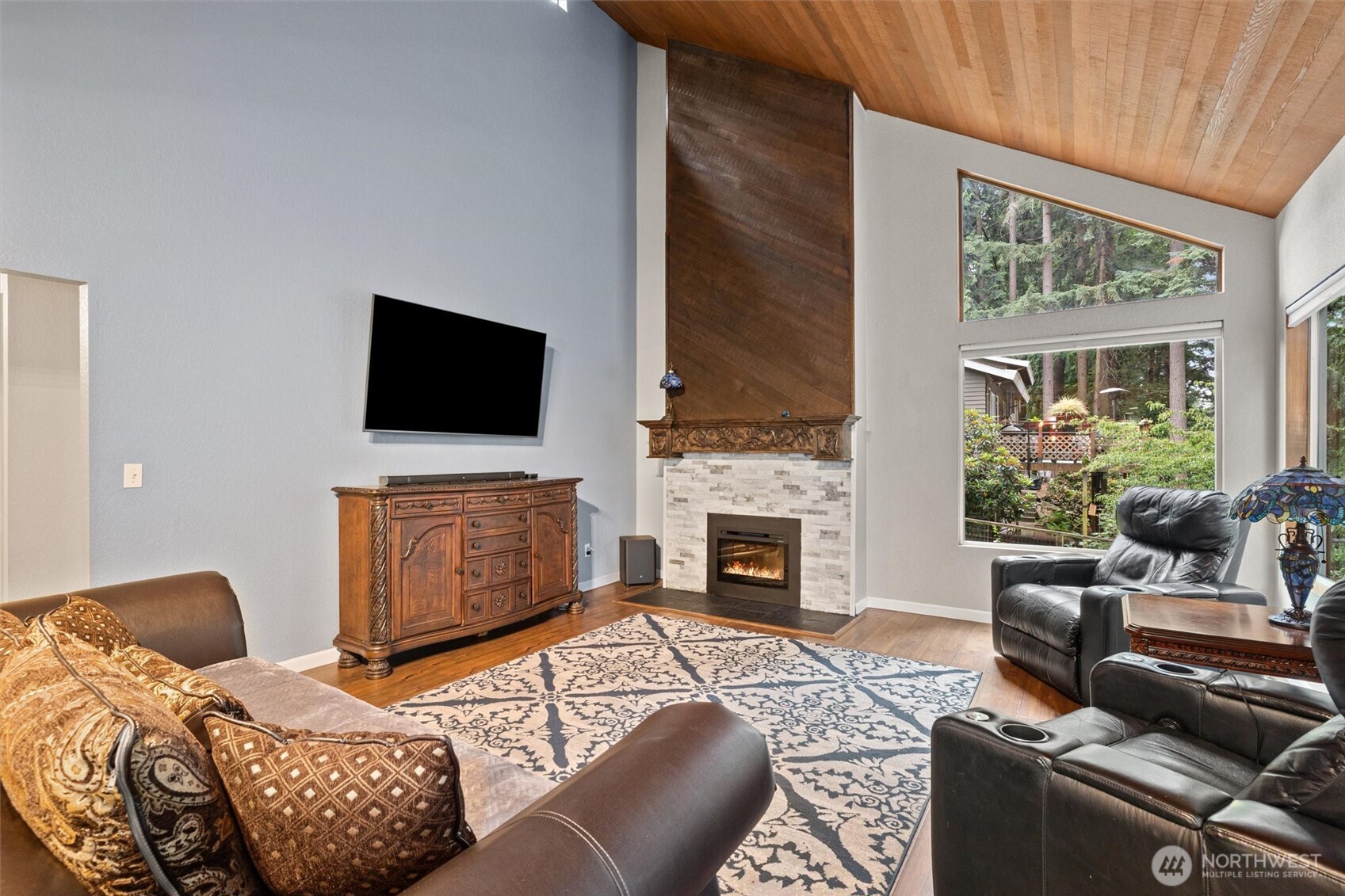 19833 95th Avenue Northeast Bothell, WA 98011 - Photo 9 of 39 a living room with furniture a fireplace and a flat screen tv