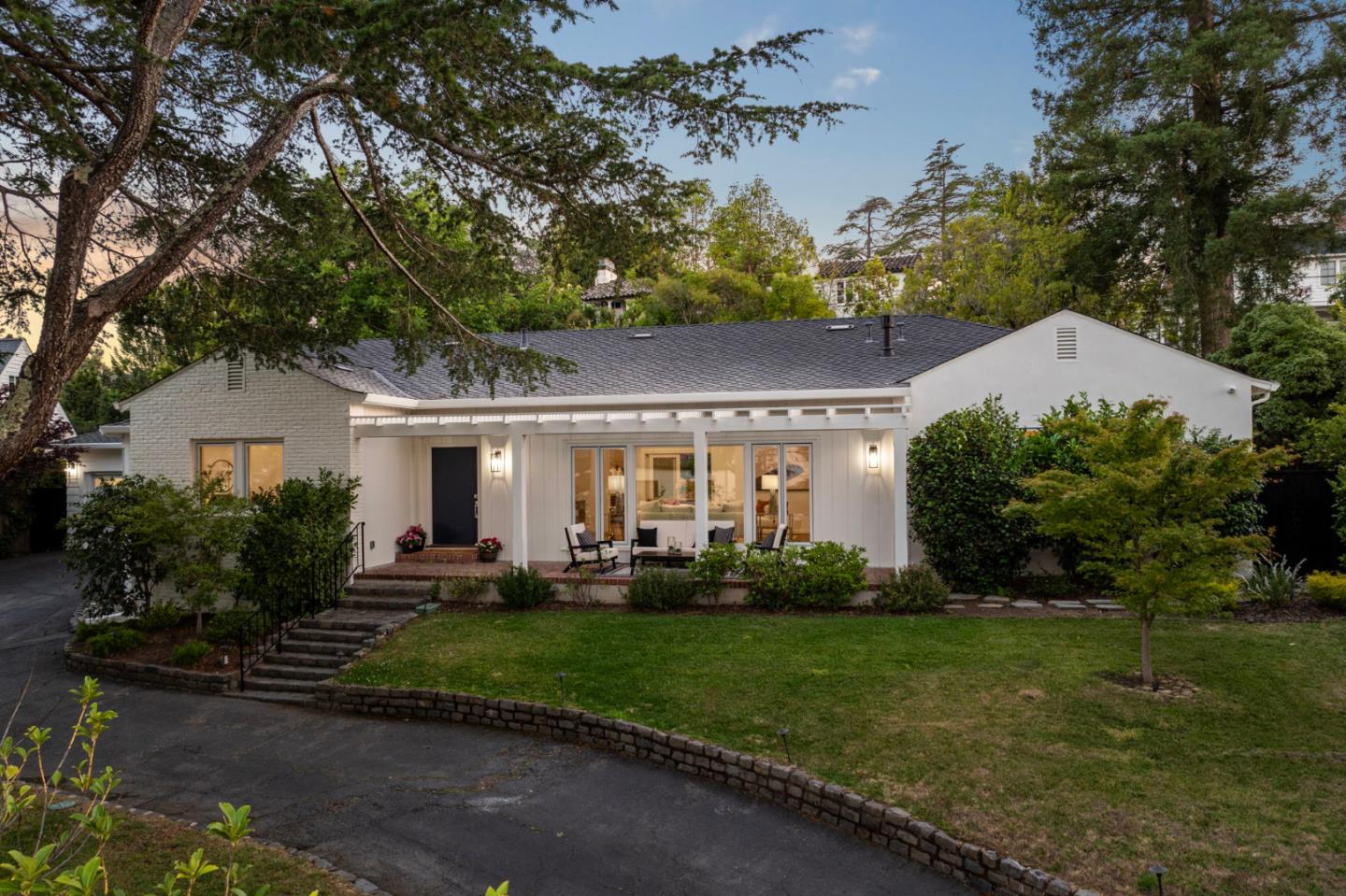 a front view of a house with a yard and outdoor seating