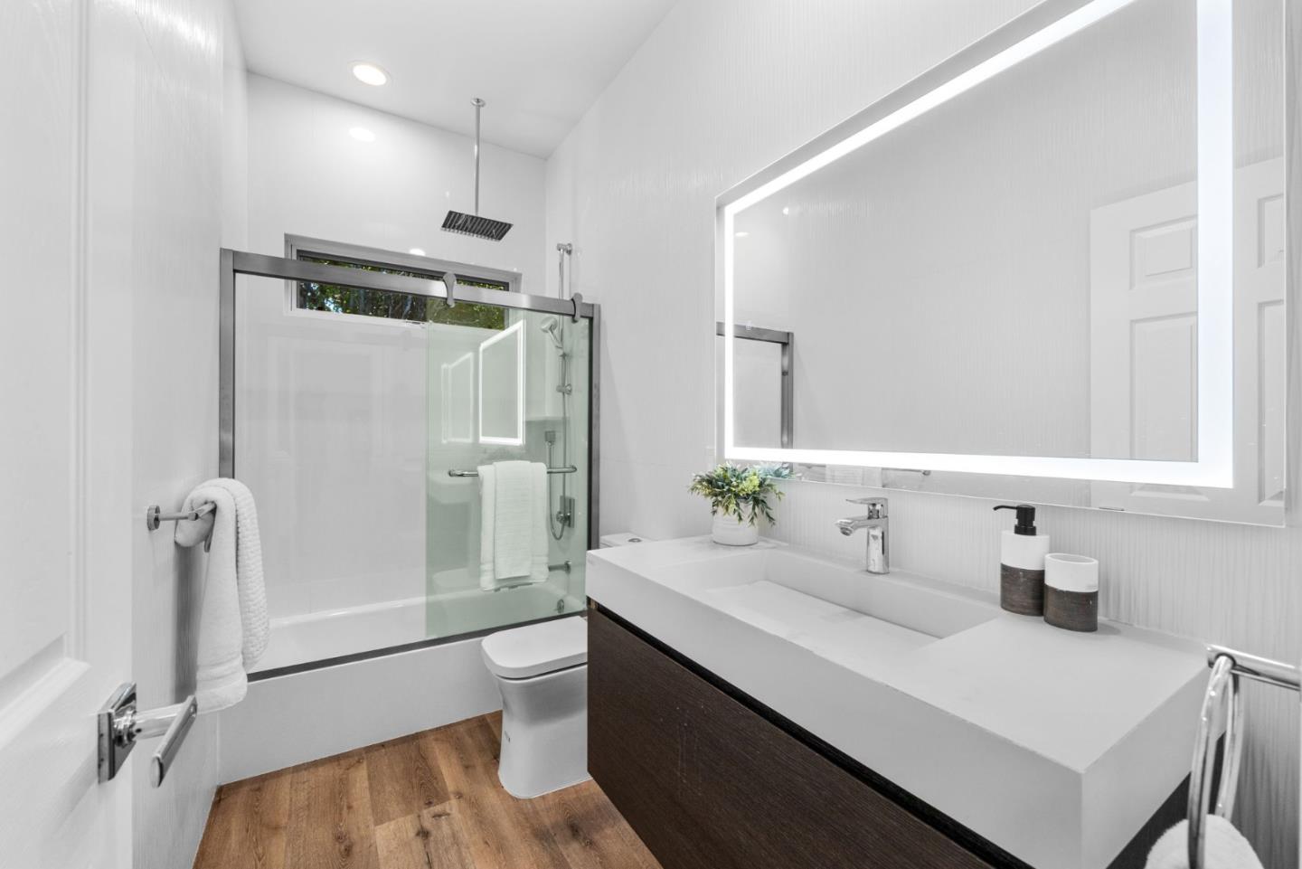 415 El Centro Road Hillsborough, CA 94010 - Photo 36 of 60 a bathroom with a sink toilet double vanity and shower