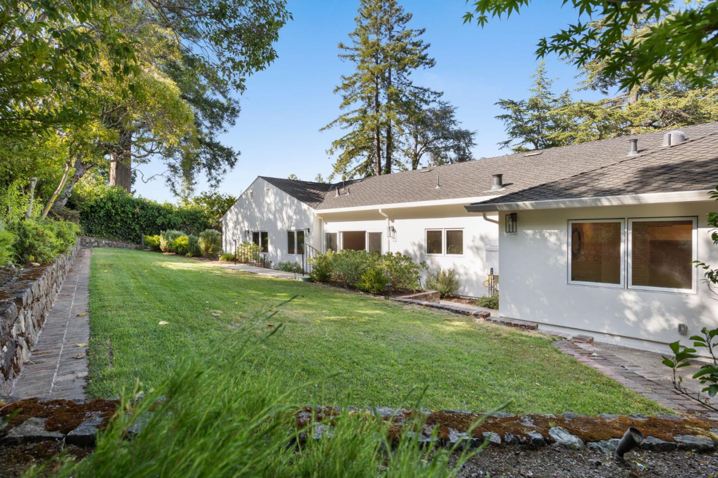 415 El Centro Road Hillsborough, CA 94010 - Photo 47 of 60 a front view of a house with a garden and yard