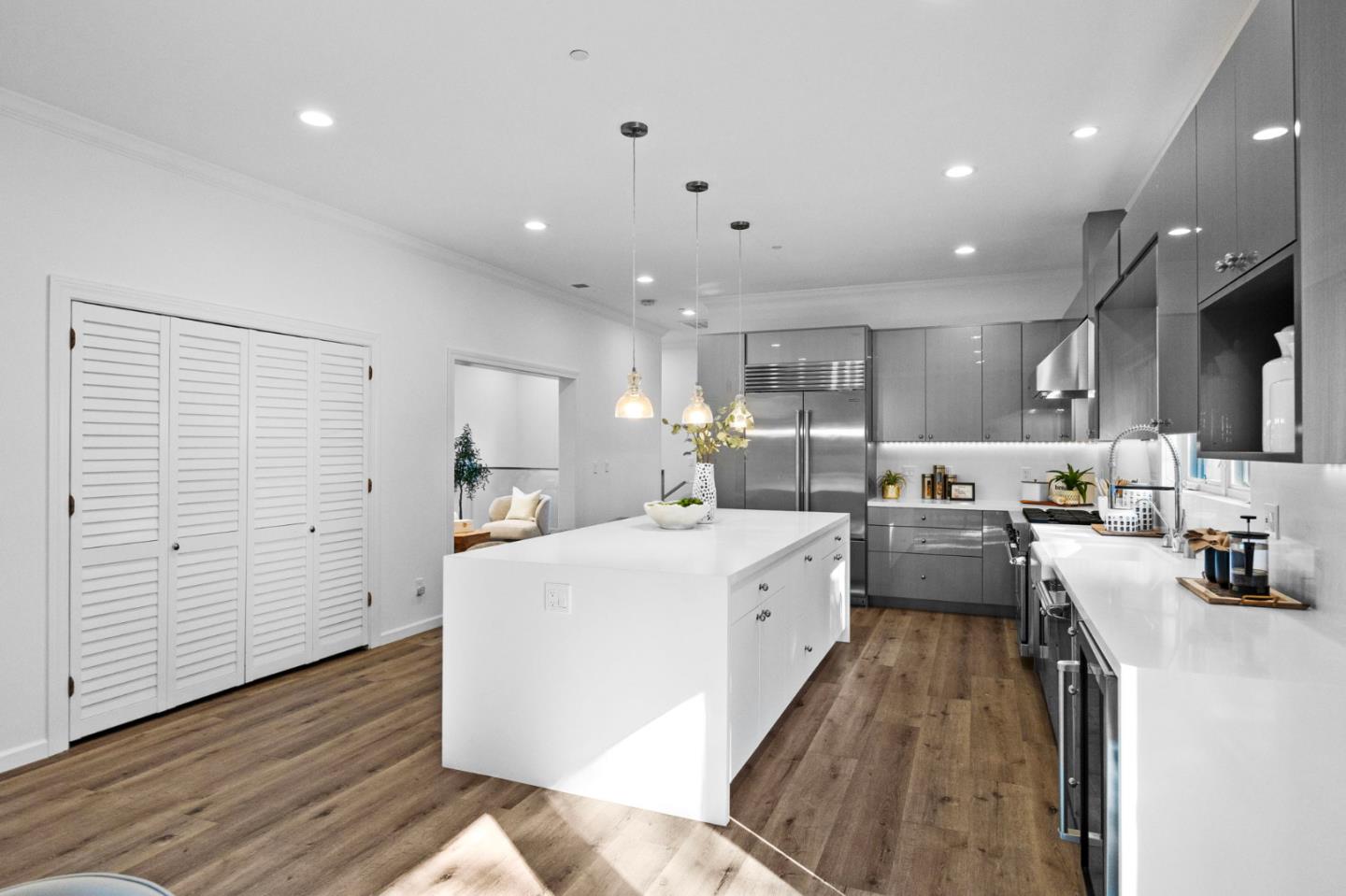 415 El Centro Road Hillsborough, CA 94010 - Photo 7 of 60 a large white kitchen with lots of counter space wooden floor and appliances