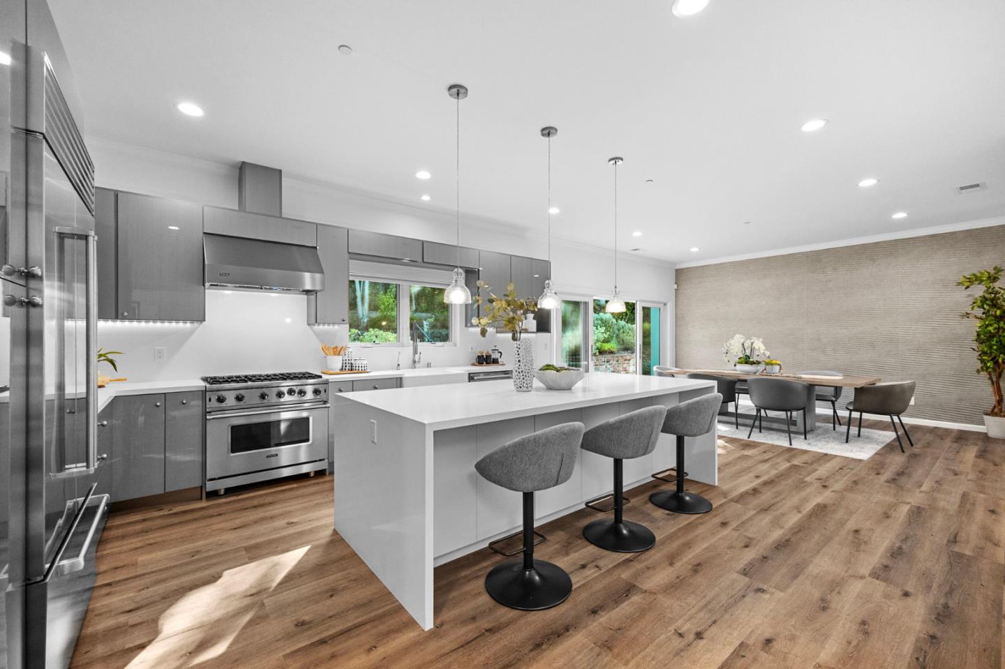 415 El Centro Road Hillsborough, CA 94010 - Photo 8 of 60 a kitchen with stainless steel appliances a stove a sink a oven a dining table and chairs