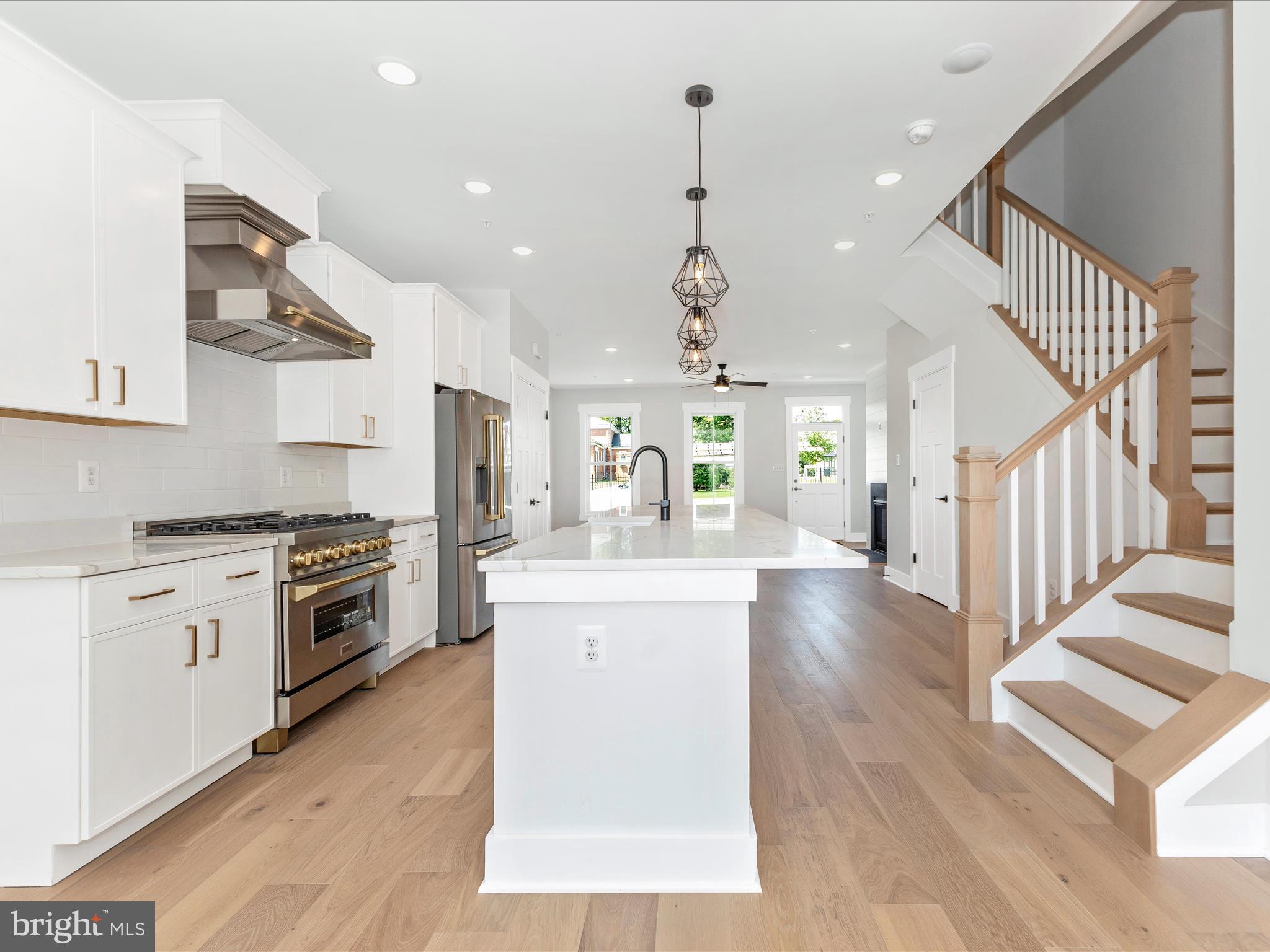 252 South Carroll Street Frederick, MD 21701 - Photo 15 of 68 a large kitchen with stainless steel appliances granite countertop a lot of counter space and wooden floors