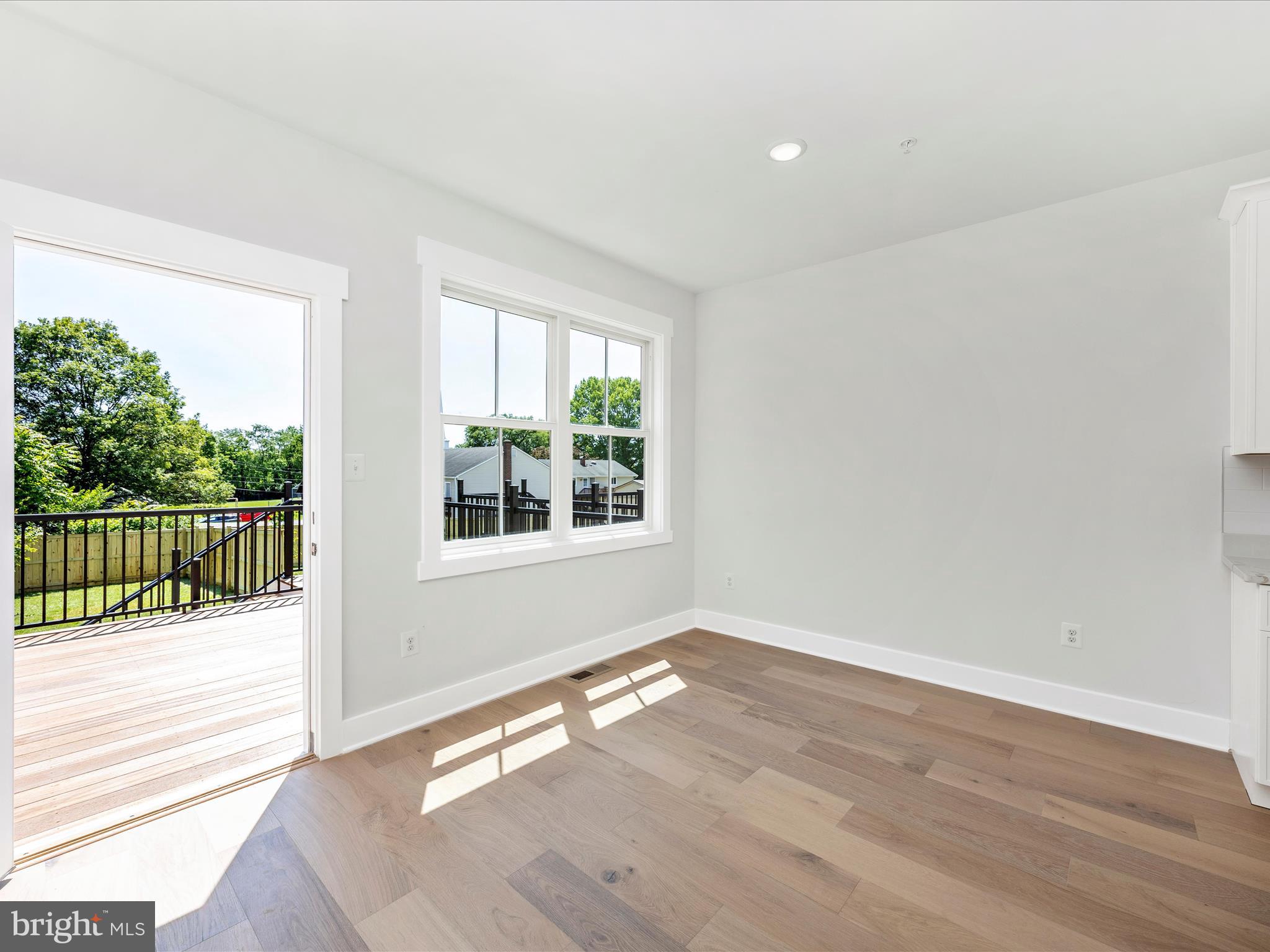 252 South Carroll Street Frederick, MD 21701 - Photo 16 of 68 an empty room with wooden floor and windows