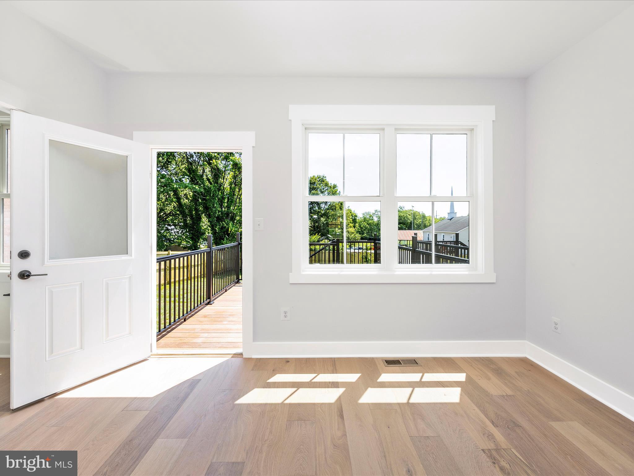 252 South Carroll Street Frederick, MD 21701 - Photo 19 of 68 a view of empty room with wooden floor and fan