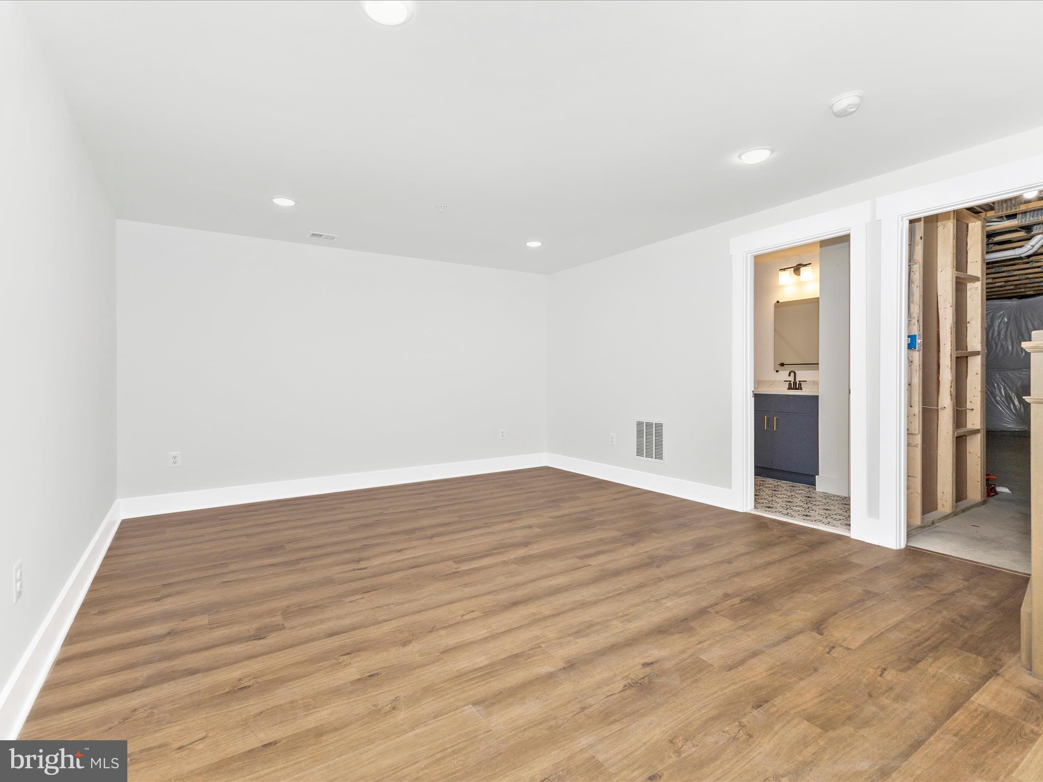 252 South Carroll Street Frederick, MD 21701 - Photo 22 of 68 a view of an empty room with wooden floor and entryway
