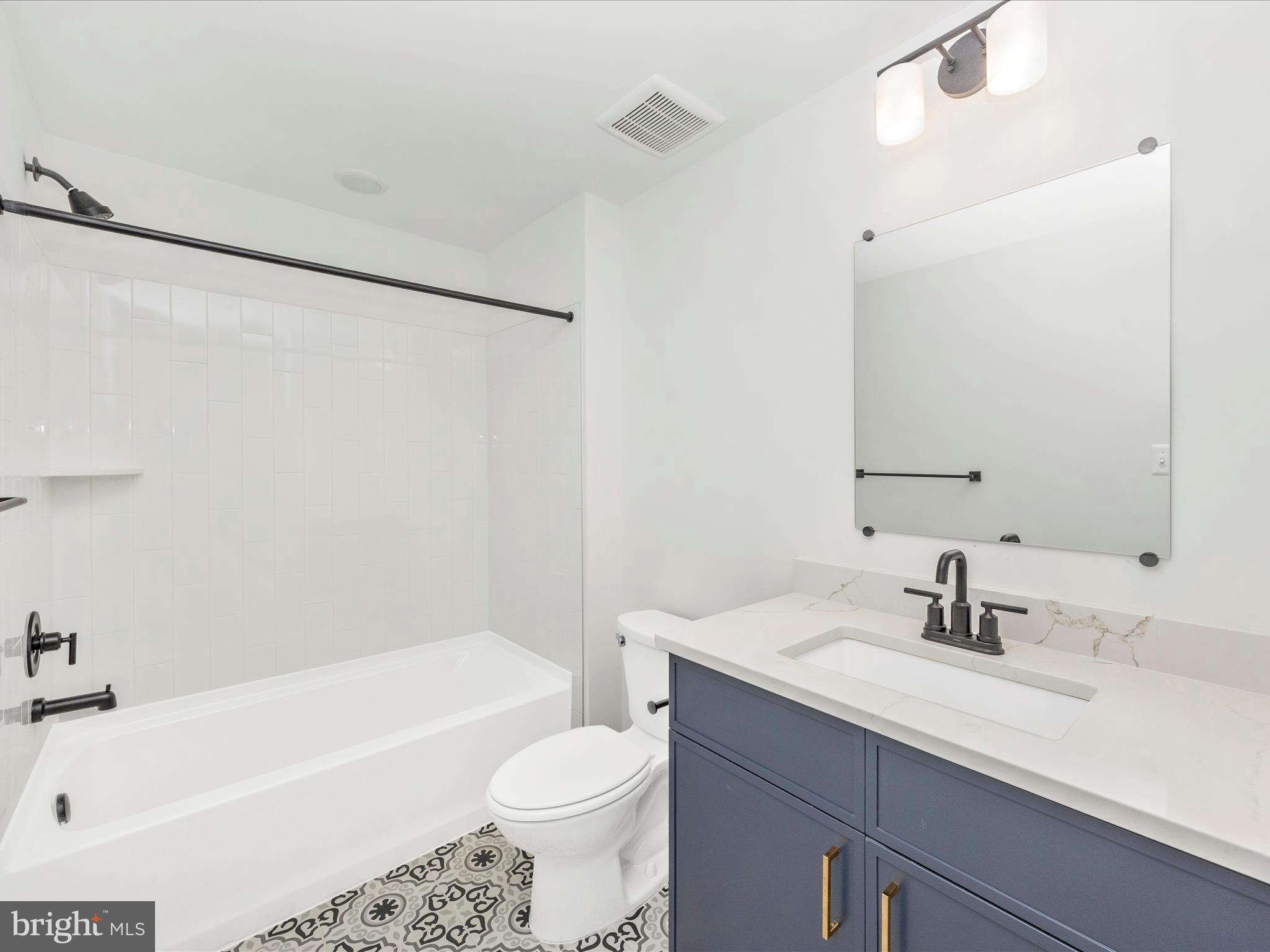 252 South Carroll Street Frederick, MD 21701 - Photo 26 of 68 a bathroom with a sink a toilet a bathtub and a mirror