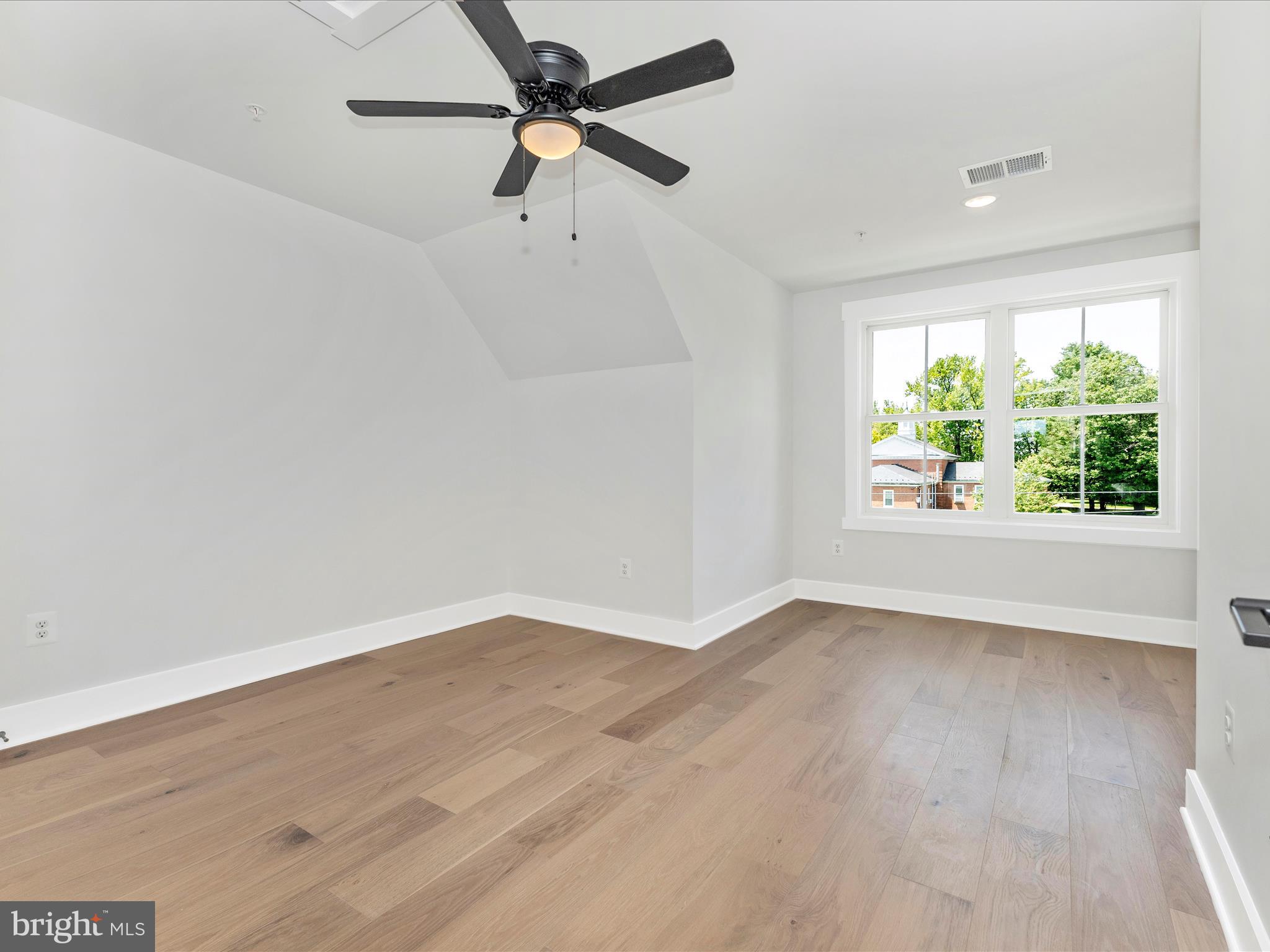 252 South Carroll Street Frederick, MD 21701 - Photo 28 of 68 an empty room with wooden floor fan and windows