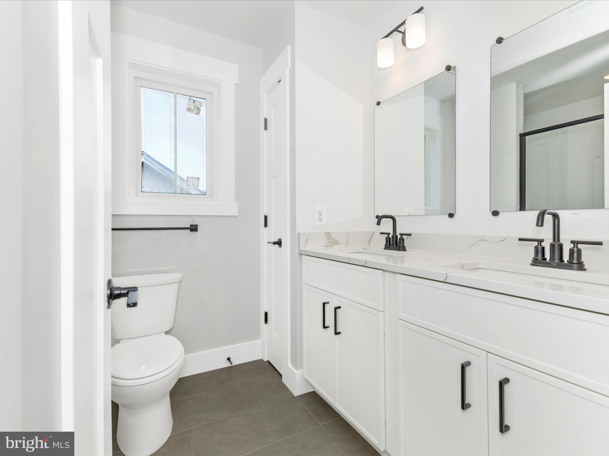 252 South Carroll Street Frederick, MD 21701 - Photo 30 of 68 a bathroom with a toilet sink and mirror