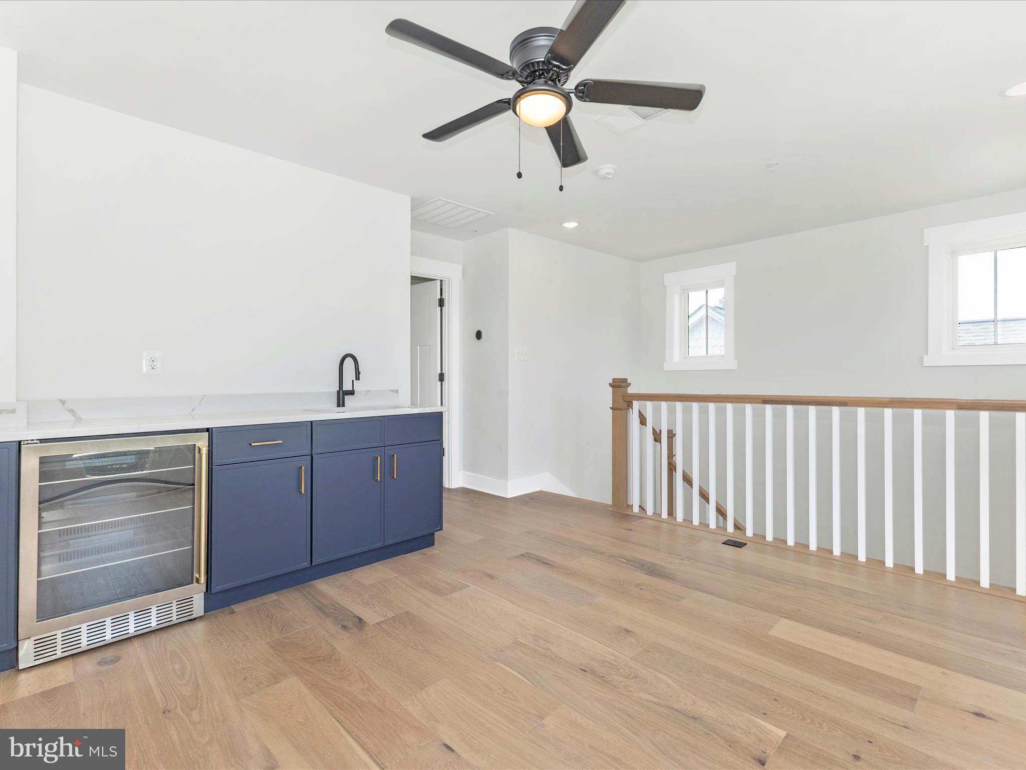 252 South Carroll Street Frederick, MD 21701 - Photo 34 of 68 a view of a room with a ceiling fan and wooden floor
