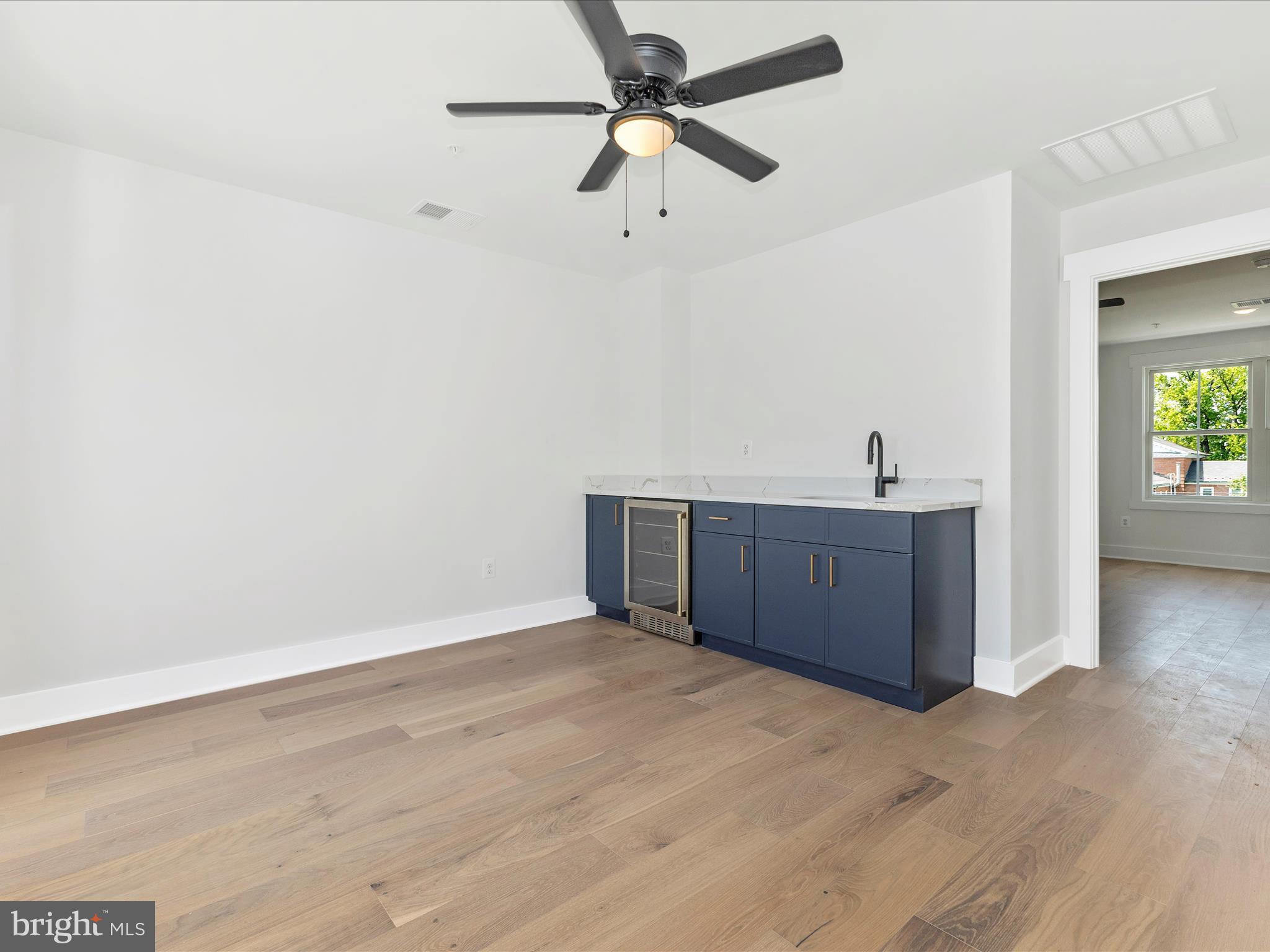 252 South Carroll Street Frederick, MD 21701 - Photo 35 of 68 a view of a room with a ceiling fan and wooden floor