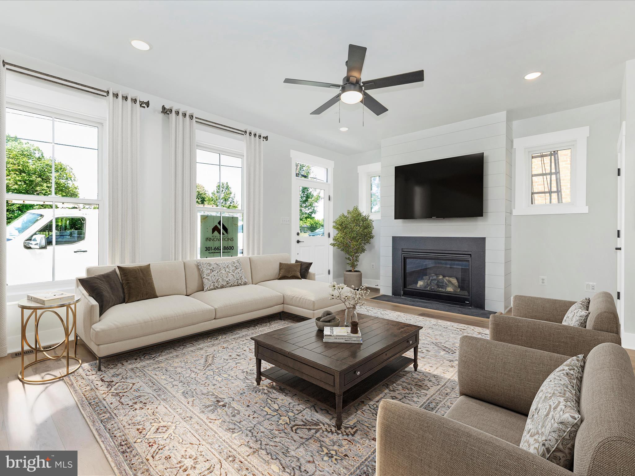 252 South Carroll Street Frederick, MD 21701 - Photo 4 of 68 a living room with furniture a flat screen tv and a fireplace
