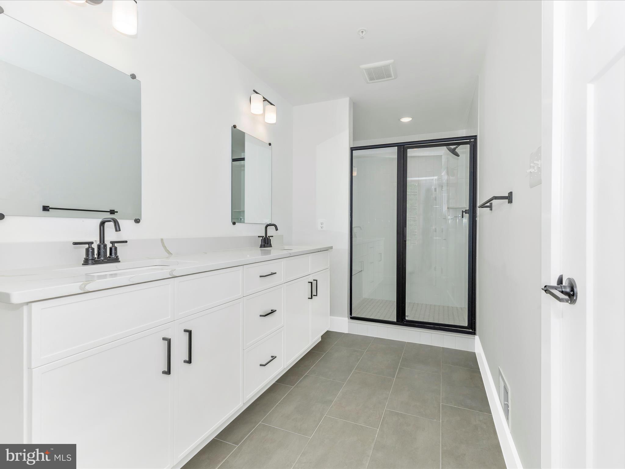 252 South Carroll Street Frederick, MD 21701 - Photo 45 of 68 a bathroom with a double vanity sink mirror and shower