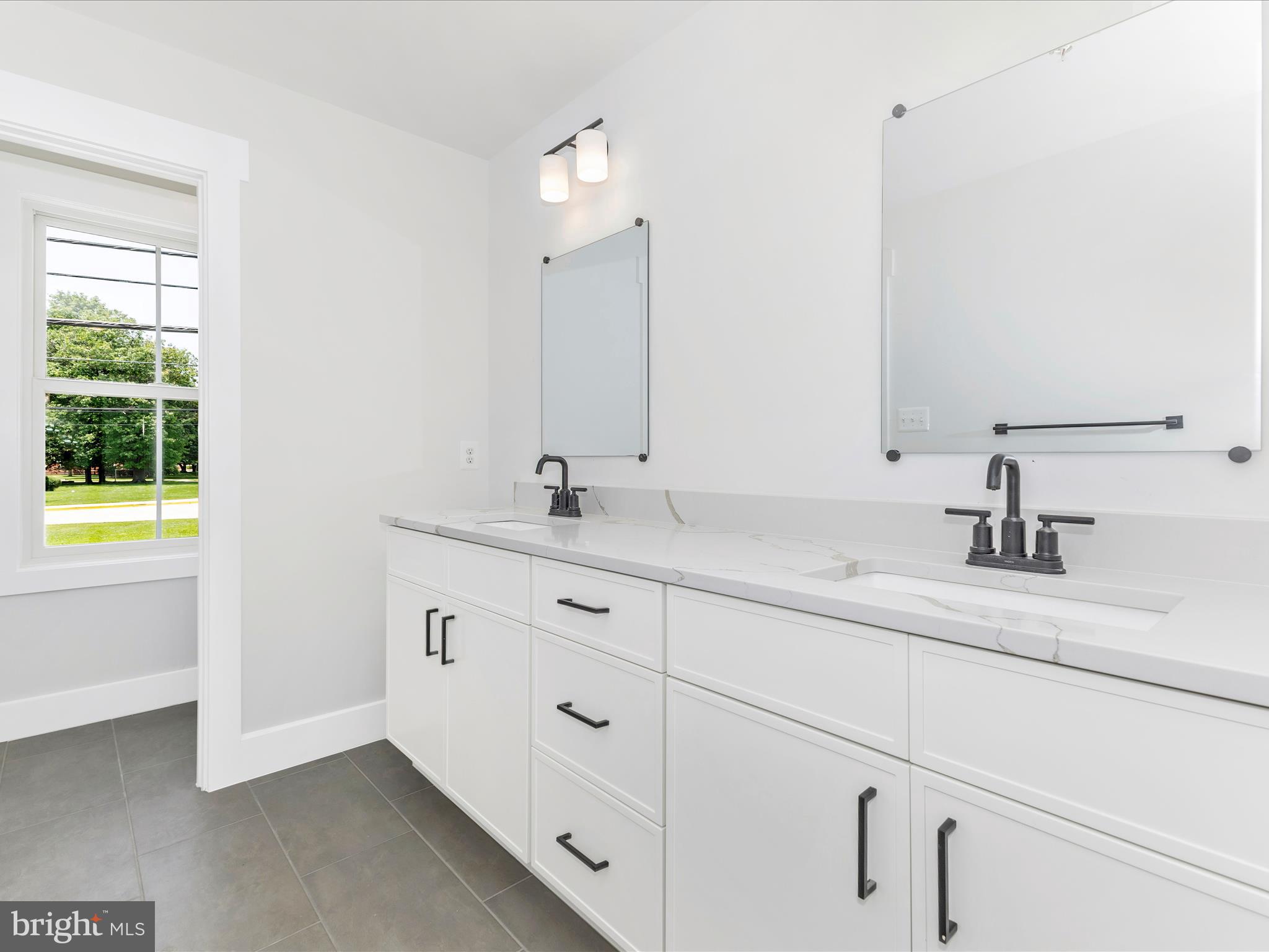 252 South Carroll Street Frederick, MD 21701 - Photo 46 of 68 a bathroom with a sink and a mirror