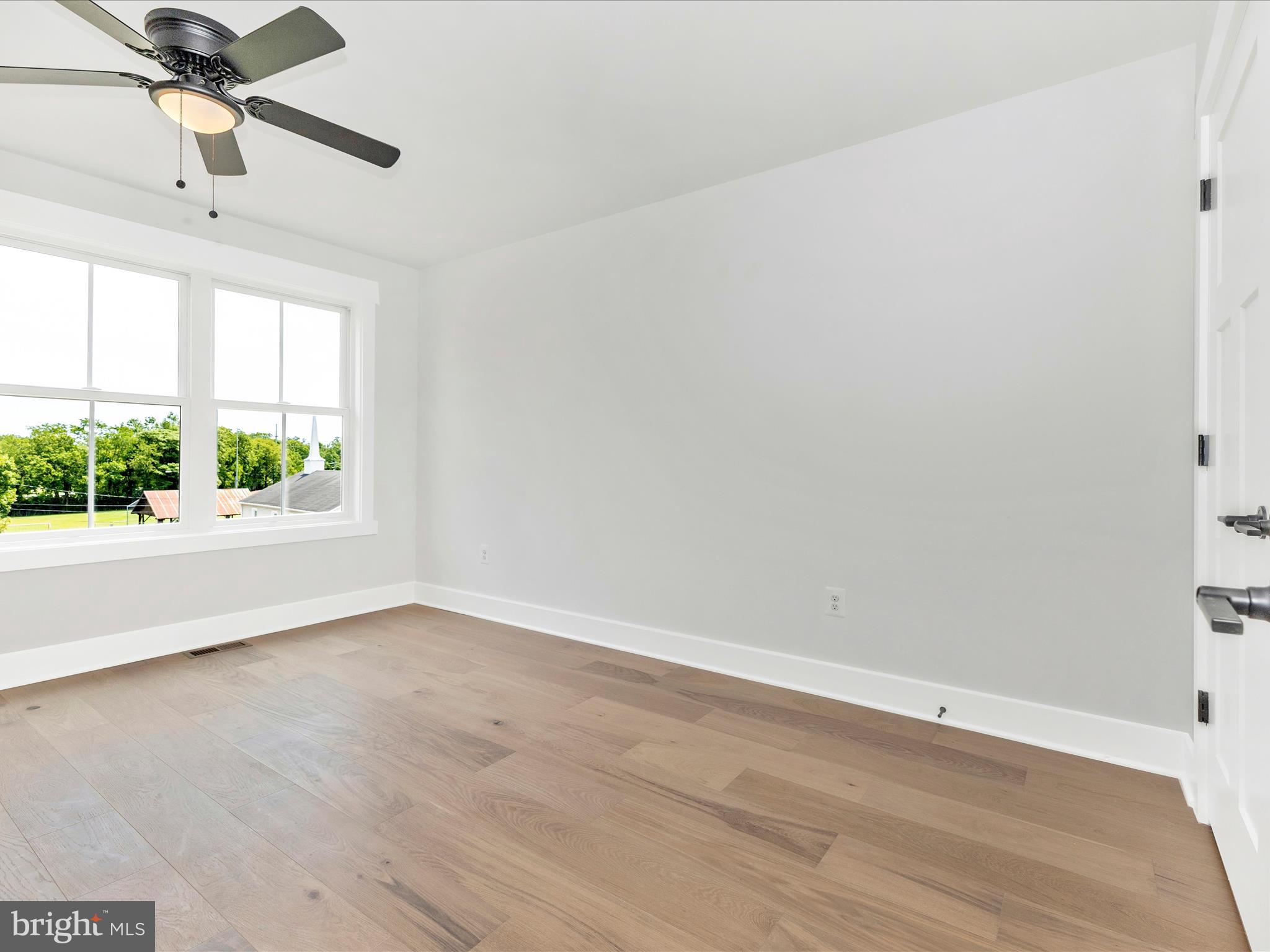 252 South Carroll Street Frederick, MD 21701 - Photo 47 of 68 an empty room with wooden floor fan and windows
