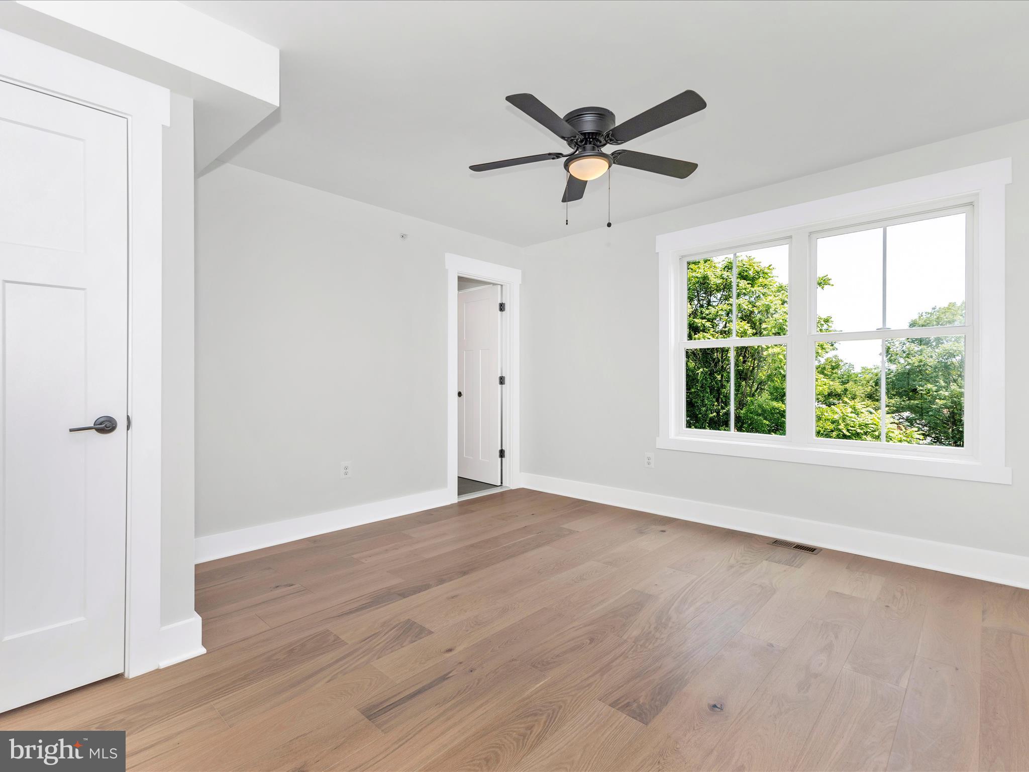 252 South Carroll Street Frederick, MD 21701 - Photo 48 of 68 an empty room with wooden floor fan and windows