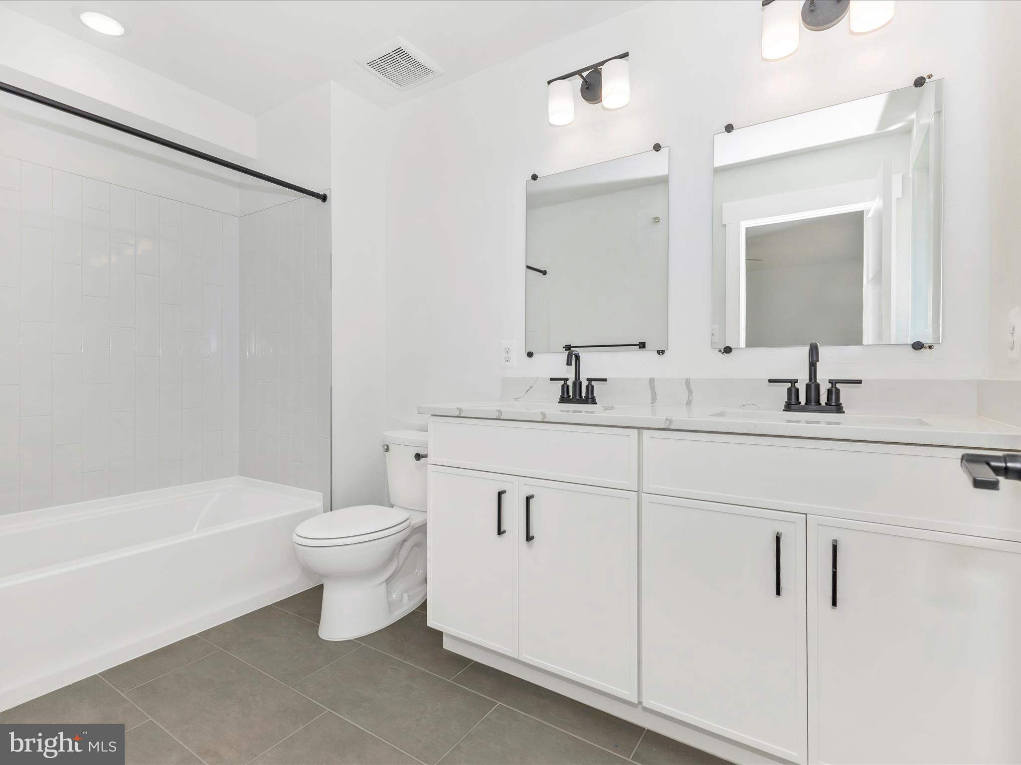 252 South Carroll Street Frederick, MD 21701 - Photo 50 of 68 a bathroom with a double vanity sink toilet and shower