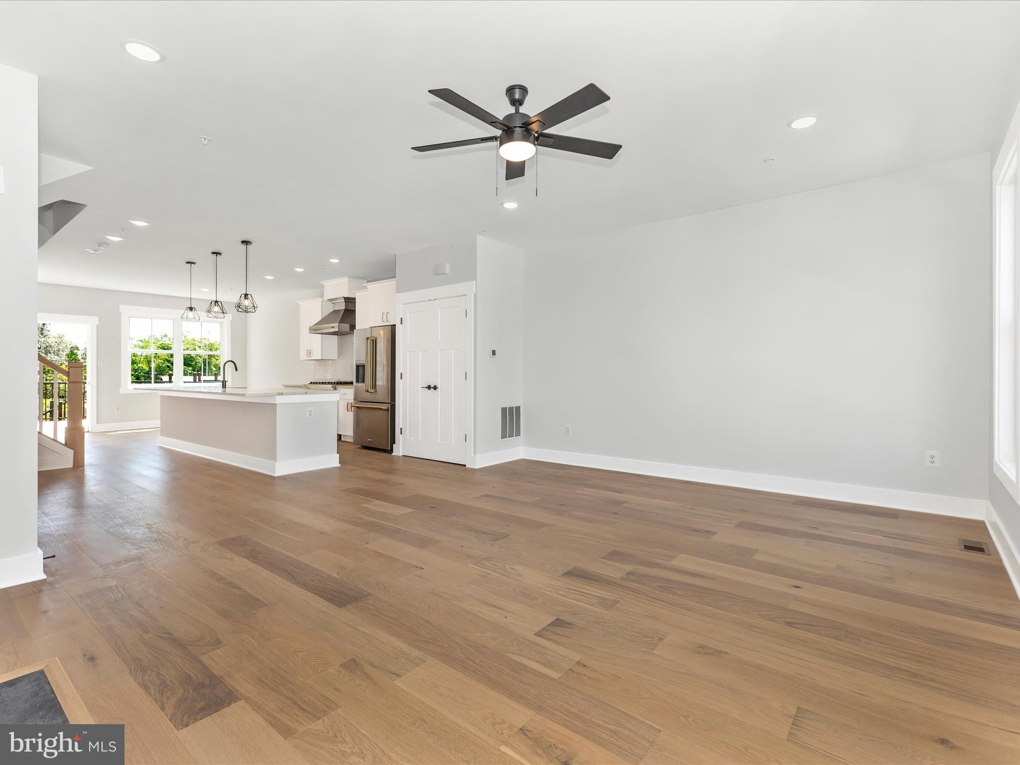 252 South Carroll Street Frederick, MD 21701 - Photo 6 of 68 an empty room with wooden floor and a ceiling fan