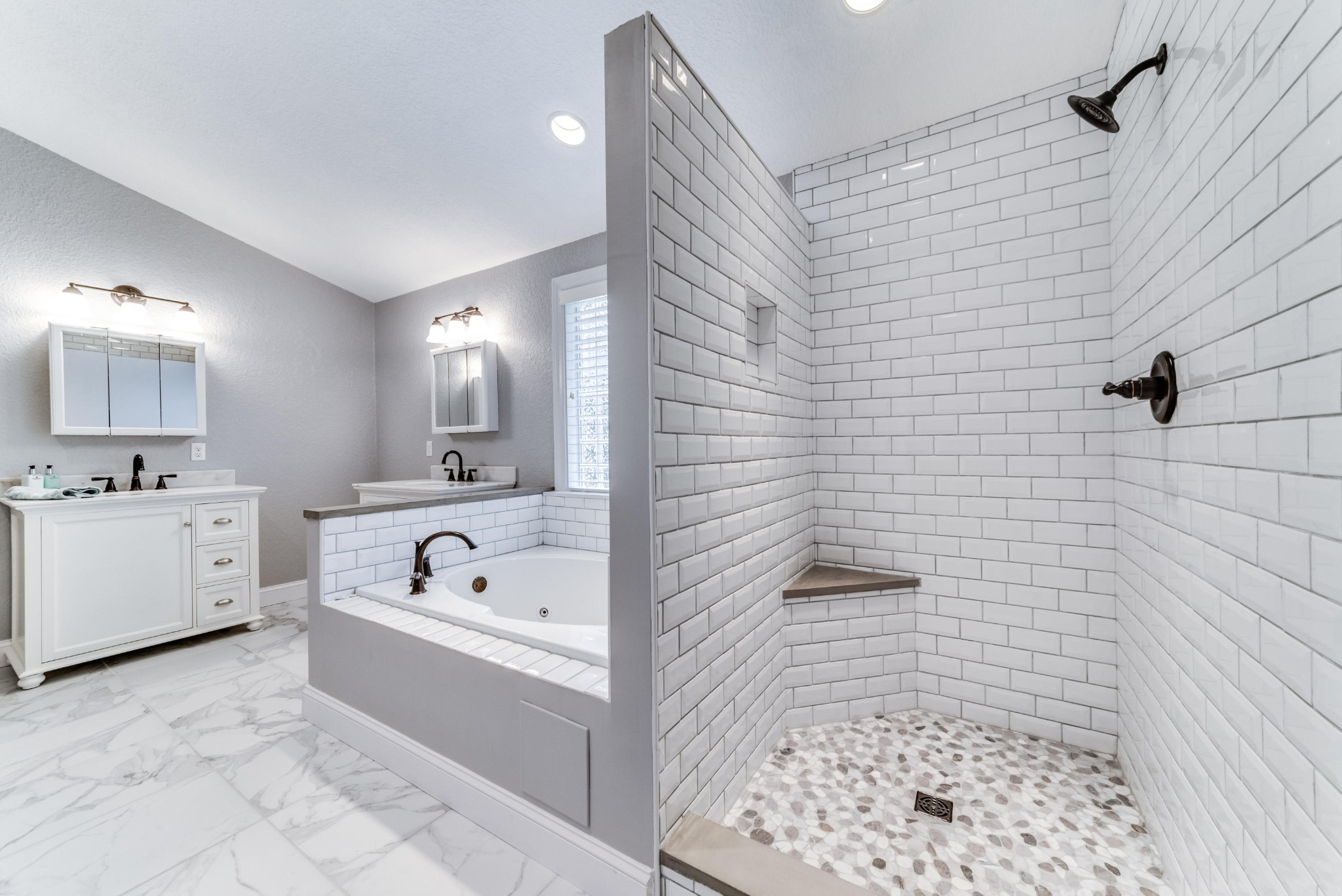 3405 Shagbark Road Powell, TN 37849 - Photo 9 of 20 a bathroom with a bathtub a sink a mirror a shower and vanity