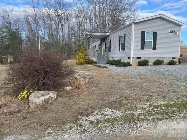 a view of a house with a backyard and sitting area