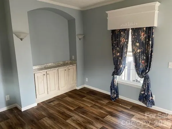 a view of a livingroom with wooden floor and stairs