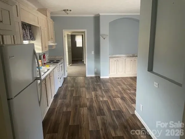 a view of a kitchen from the hallway