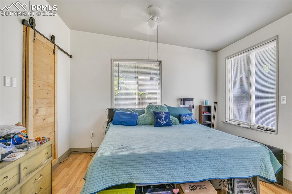 1330 West 3rd Street Florence, CO 81226 - Photo 14 of 34 a bedroom with a bed and large windows