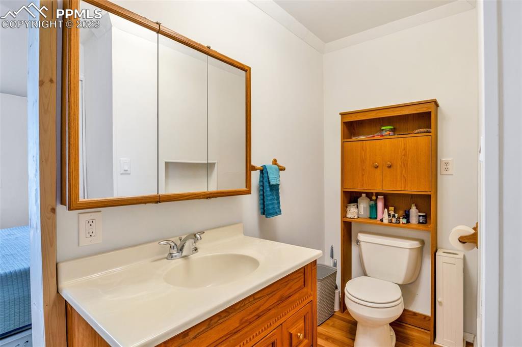 1330 West 3rd Street Florence, CO 81226 - Photo 15 of 34 a bathroom with a sink a toilet and mirror