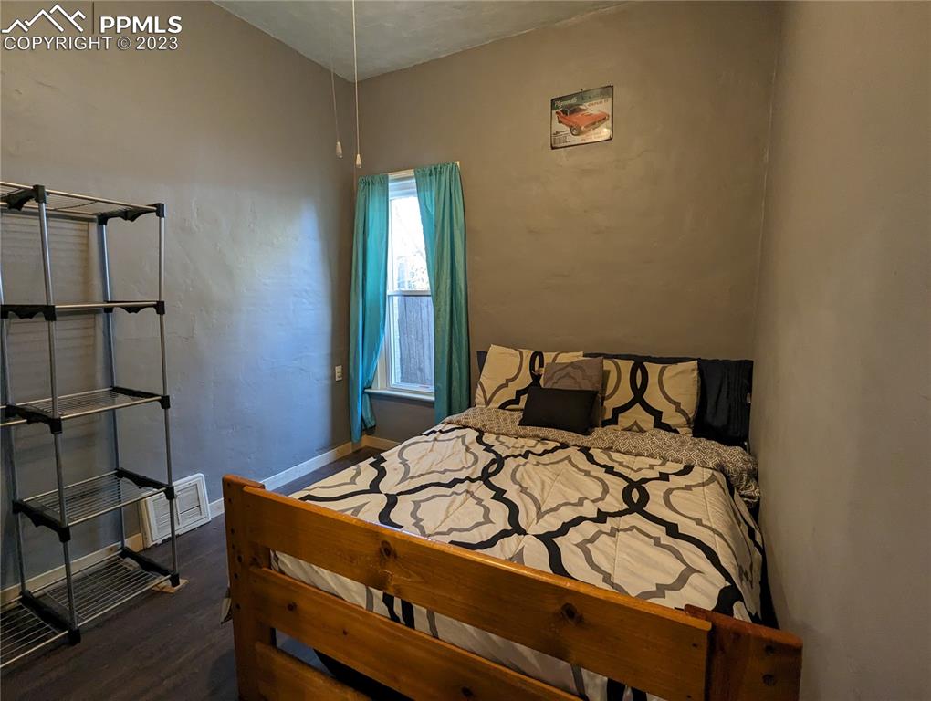 1330 West 3rd Street Florence, CO 81226 - Photo 17 of 34 a bed sitting in a bedroom next to a window