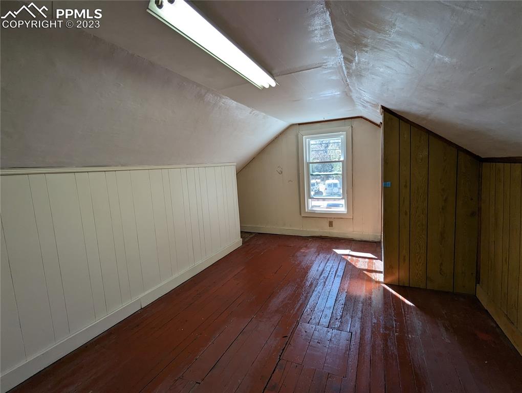1330 West 3rd Street Florence, CO 81226 - Photo 23 of 34 an empty room with wooden floor and windows